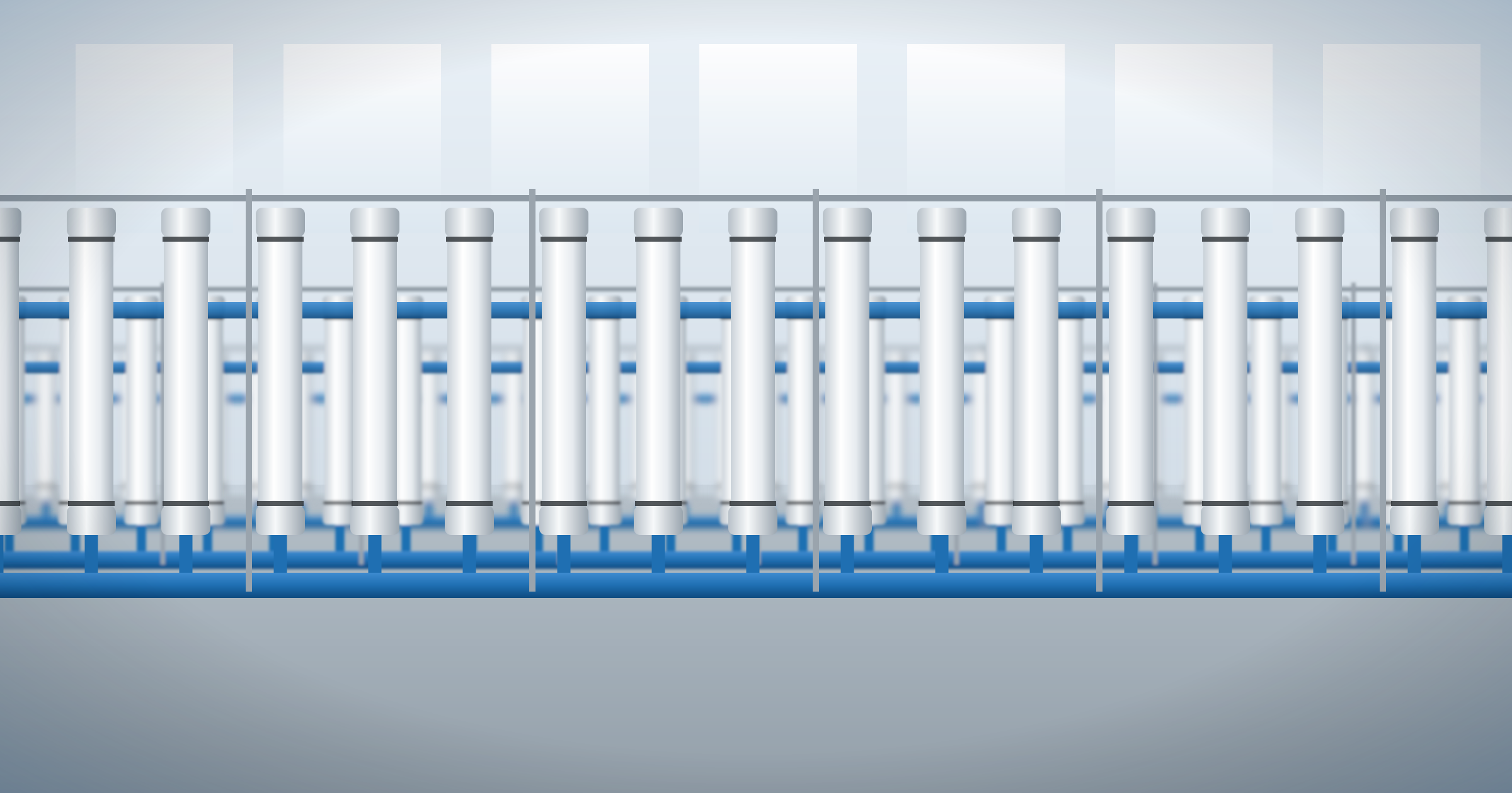 Illustration of rows of white cylindrical membrane filtration modules on blue pipework inside a bright water treatment plant.